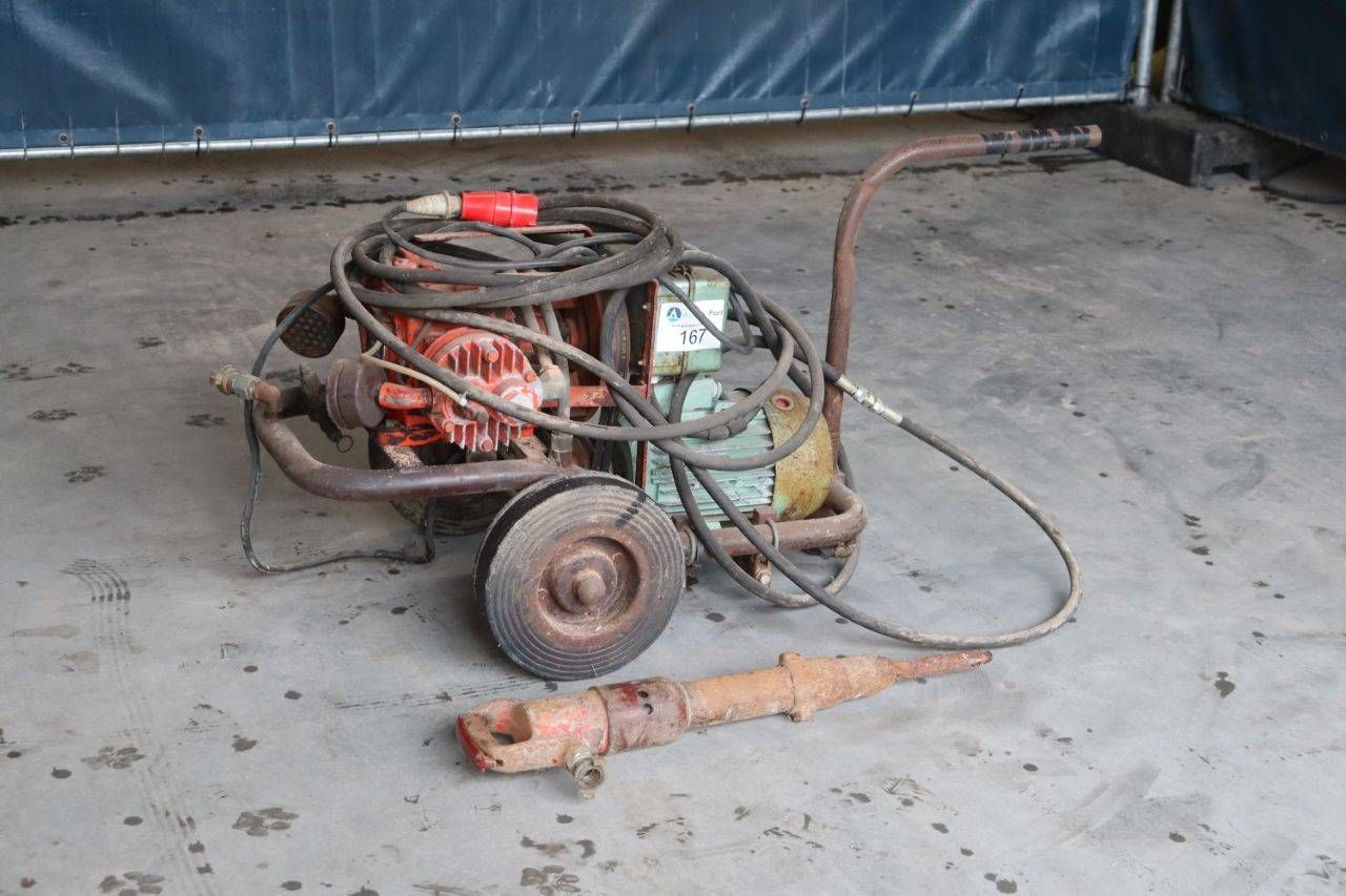 Brown mobile air compressor with pneumatic breaker hammer