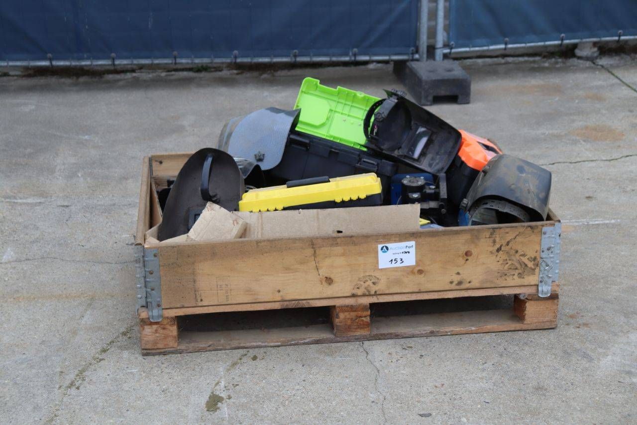Crate with welding helmets, toolboxes, batteries and chargers