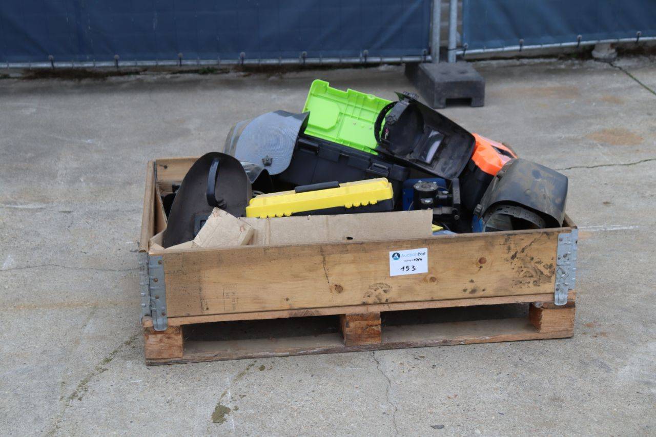 Crate with welding helmets, toolboxes, batteries and chargers